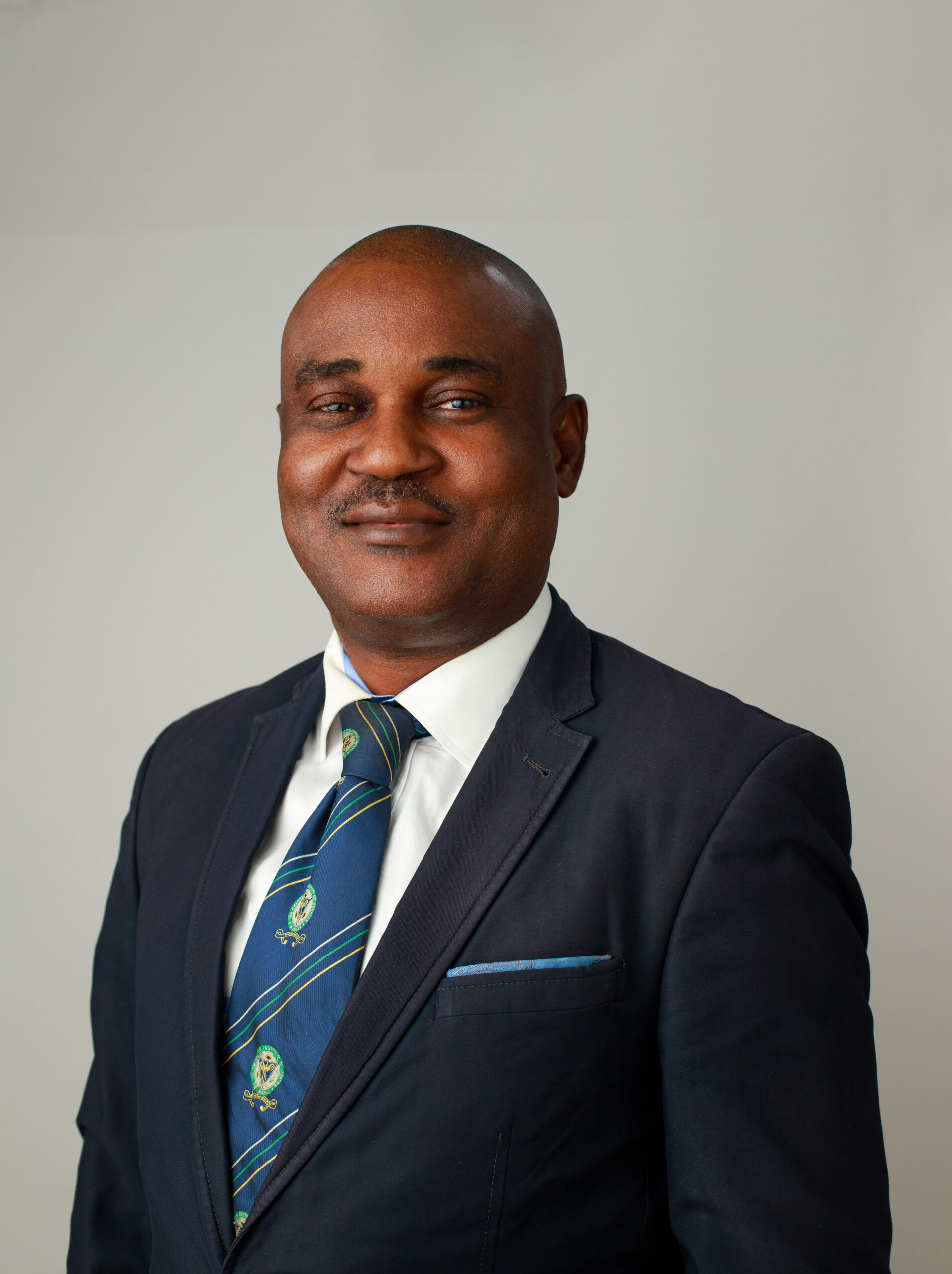 Headshot photo of Dr. Uzoma Achagamonu - Registrar James Hope University