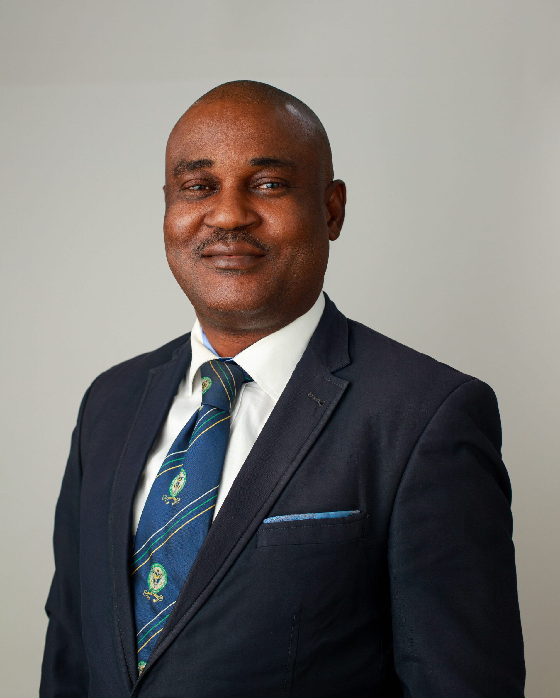 Headshot photo of Dr. Uzoma Achagamonu - Registrar James Hope University